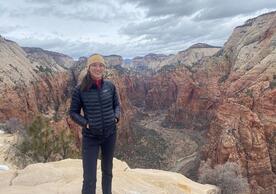 Incoming FAS faculty member Elizabeth Yankovsky, Assistant Professor of Earth and Planetary Sciences, stands above a canyon.