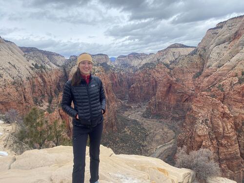 Incoming FAS faculty member Elizabeth Yankovsky, Assistant Professor of Earth and Planetary Sciences, stands above a canyon.